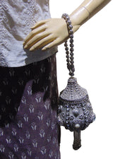 Round clutch bag in perforated-patterned