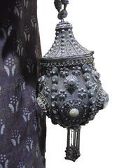 Round clutch bag in perforated-patterned