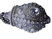 Round clutch bag in perforated-patterned