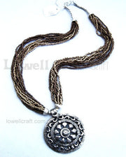 SEED BEAD NECKLACE WITH ANTIQUE METAL PENDANT